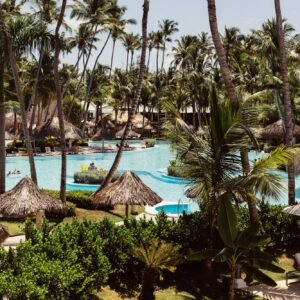 resort pool, leaf umbrellas, and the beach in Punta Cana, Dominican Republic