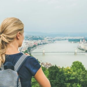 Young woman traveler looking at Danube river, Budapest, Hungary